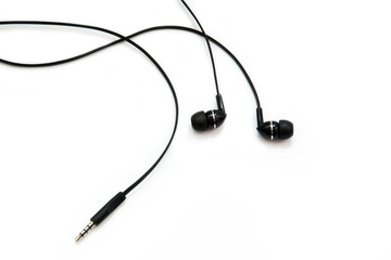 Black headphones for listening to music and sound on portable devices: music player, smartphone, laptop and jack for connection on a white background. Ear plugs.