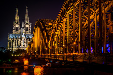 Nighttime at the Hohenzollern Bridge with Cologne Cathedral in Cologne, Germany.