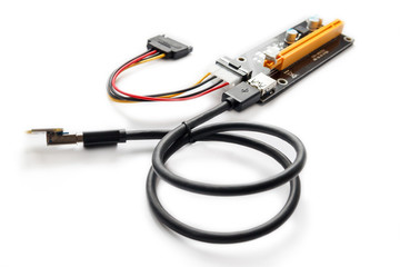 Adapter or riser PCI-E for mining on video cards. Device for adaptation 1X PCI-E to 16X slot and add video graphic cards to motherboard. Closeup on white background.