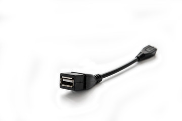 Adapter OTG USB - Micro USB to connect to a smartphone, tablet and other devices on a white background.