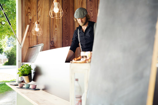 Cook working in food truck, Innsbruck Tirol, Austria