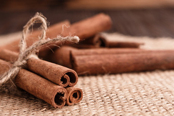 Cinnamon essential oil on a wooden background