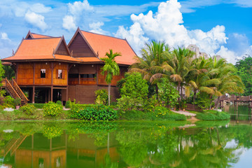 A typical Khmer Keng house on pilings with its lovely roofs, stands next to a beautiful lake in the...
