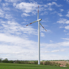 Wind Energy: Modern three bladed wind turbine in the undulating landscape in Eastern Thuringia on a...