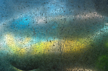 Background or texture - a metal surface with scratches and chips, blurred color spots.