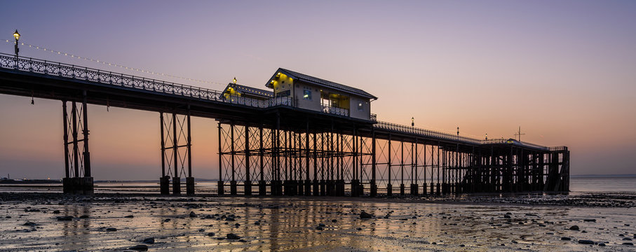 Sunrise at Penarth Pier. Penarth is a coastal town in South Wales, UK, near Cardiff the capital of Wales.  The pier is a fine example of Victorian architecture