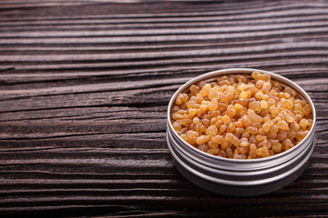 frankincense essential oil on a wooden background
