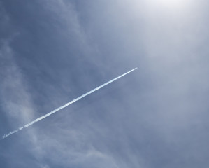 contrail of big overflying passenger airplane in the clear blue sky