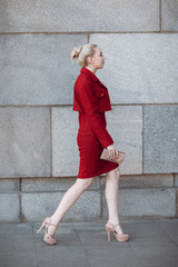 Young model girl in red business suit