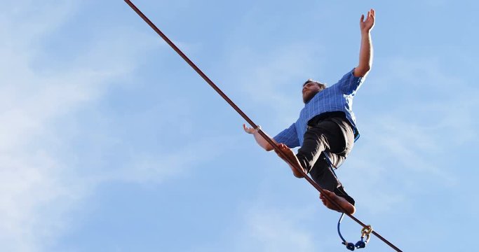 Highline athlete walking on slackline 