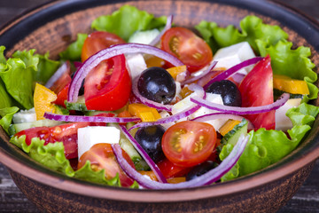 Greek salad with fresh vegetables, feta cheese and black olives