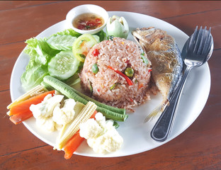 Fried rice with shrimp paste chili sauce top up with fried mackerel served with fresh and fried vegetable. Favourite delicious Thailand street food.
