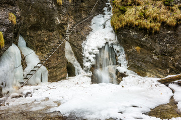 Slovakia paradise - Sucha Biela river with waterfall and ladder near. Adventure tourist path in the river canyon.