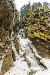 Obraz premium Slovakia paradise - Sucha Biela river with waterfall and ladder near. Adventure tourist path in the river canyon.