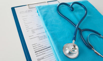 Stethoscope on a table with medical uniform