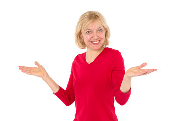 Smiling woman spread her hands in surprise. Adult 50 year old woman.