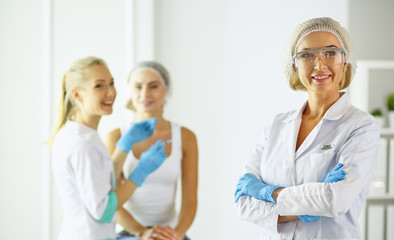 Obraz premium Permanent Makeup For Eyebrows. Beautiful Woman With Thick Brows In Beauty Salon. Beautician Doing Eyebrow Tattooing For Female Face. Beauty Procedure