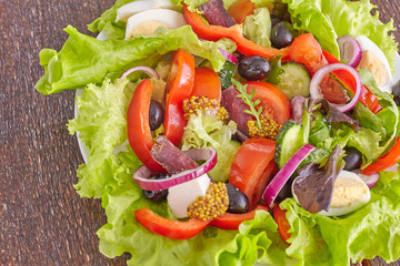 salad from fresh vegetables in a plate on a table, selective focus