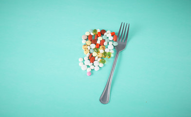 fork and pills on the table. Diet