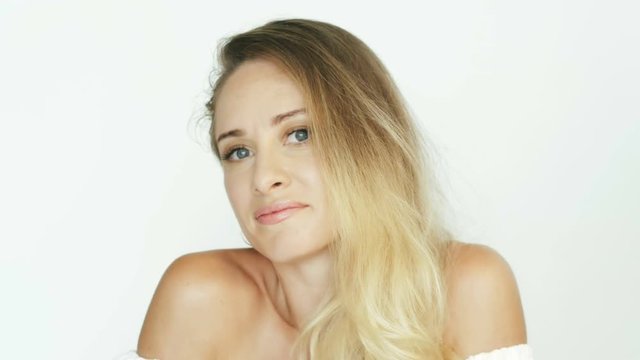 Attractive woman in white dress showing gesture with shoulders i do not know