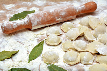 Dumplings with meat in process of cooking. Ingredients for cooking. Traditional russian and ukrainian food.