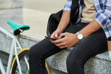 Unrecognizable Cyclist Using Smartphone