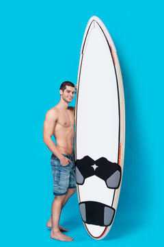 Attractive surfer holding a surfboard