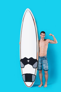 Strong surfer holding a surfboard