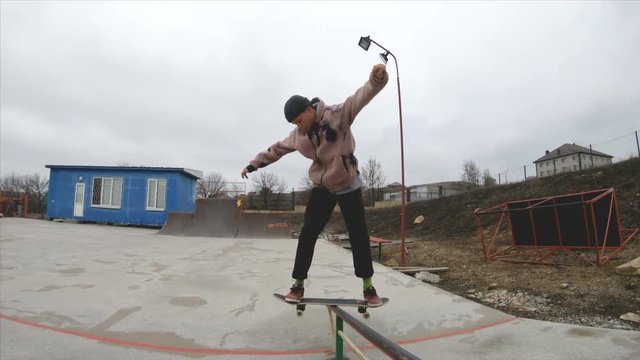 Skateboarding teenager man in skatepark extreme sport in slow motion 4K. Taken on Gopro 6 black