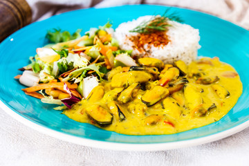 Mussels with curry sauce Rice and salad