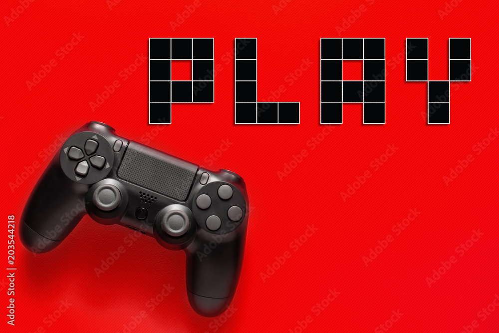 Wall mural black modern gamepad and word play on a colored background . gaming concept