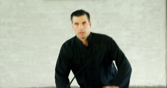 Kung fu fighter practicing martial arts with sword 