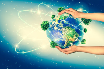 Ecological concept of the environment with the cultivation of trees on the ground in the hands. Planet Earth. Physical globe of the earth. Elements of this image furnished by NASA. 3D illustration