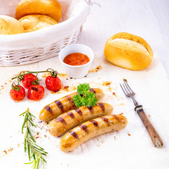 delicious bratwurst with ketchup and fresh rolls