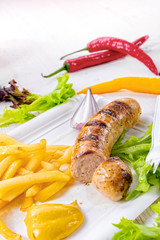 delicious grilled bratwurst with fries and mustard