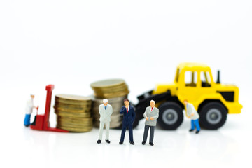 Miniature people: Worker use pallet truck with stack of coins. Image use for background business concept.