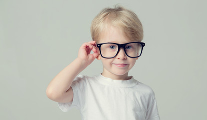 Smart little boy. 4 year old boy wearing glasses.