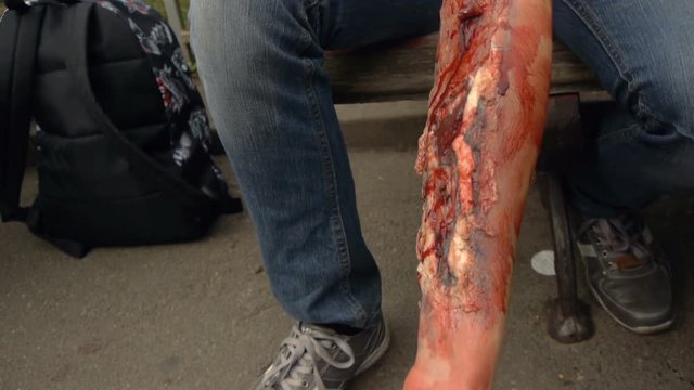 Fake wound on the guy's hand, bleeding wound on the arm of the zombie, halloween make-up