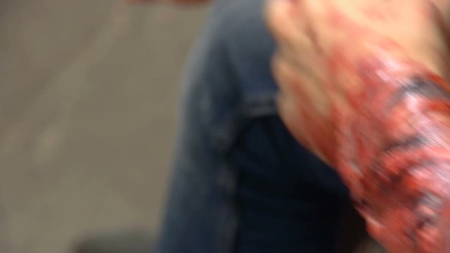 Fake wound on the guy's hand, bleeding wound on the arm of the zombie, halloween make-up