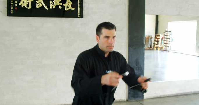 Kung fu fighter practicing martial arts with sword 