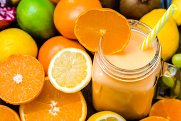 Jar of milkshake with tropical fruit or smoothie with fresh fruits blenden in jar