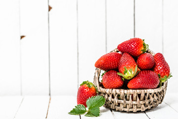 Organic strawberries on white wooden background. Red berries on table.