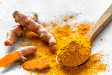 Fresh root and turmeric powder, indian spice, healthy seasoning ingredient for vegan cuisine