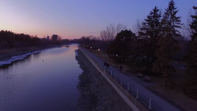 Low aerial tracking shot of a river at sunset.
