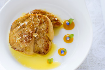 Fried Goose Liver with Apple Sauce on White Plate. Foie Gras Fine Food.