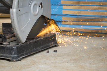 Image of worker using a sliding compound mitre saw with circular blade for cutting