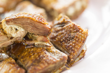 Grilled duck with crispy skin in a restaurant.