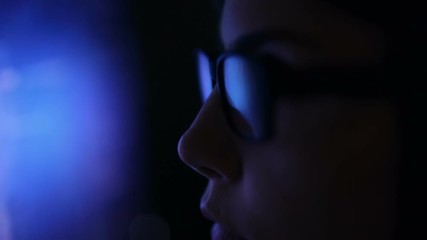 Dolly shot. Woman in glasses working in the web, serfing. Reflection in glasses from laptop. - Powered by Adobe