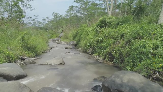 Cinematic small river aerial footage in Ledok Sambi village, Yogyakarta, Indonesia. April 2018
