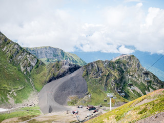 Photo of mountain slopes with vegetation and cloudy sky